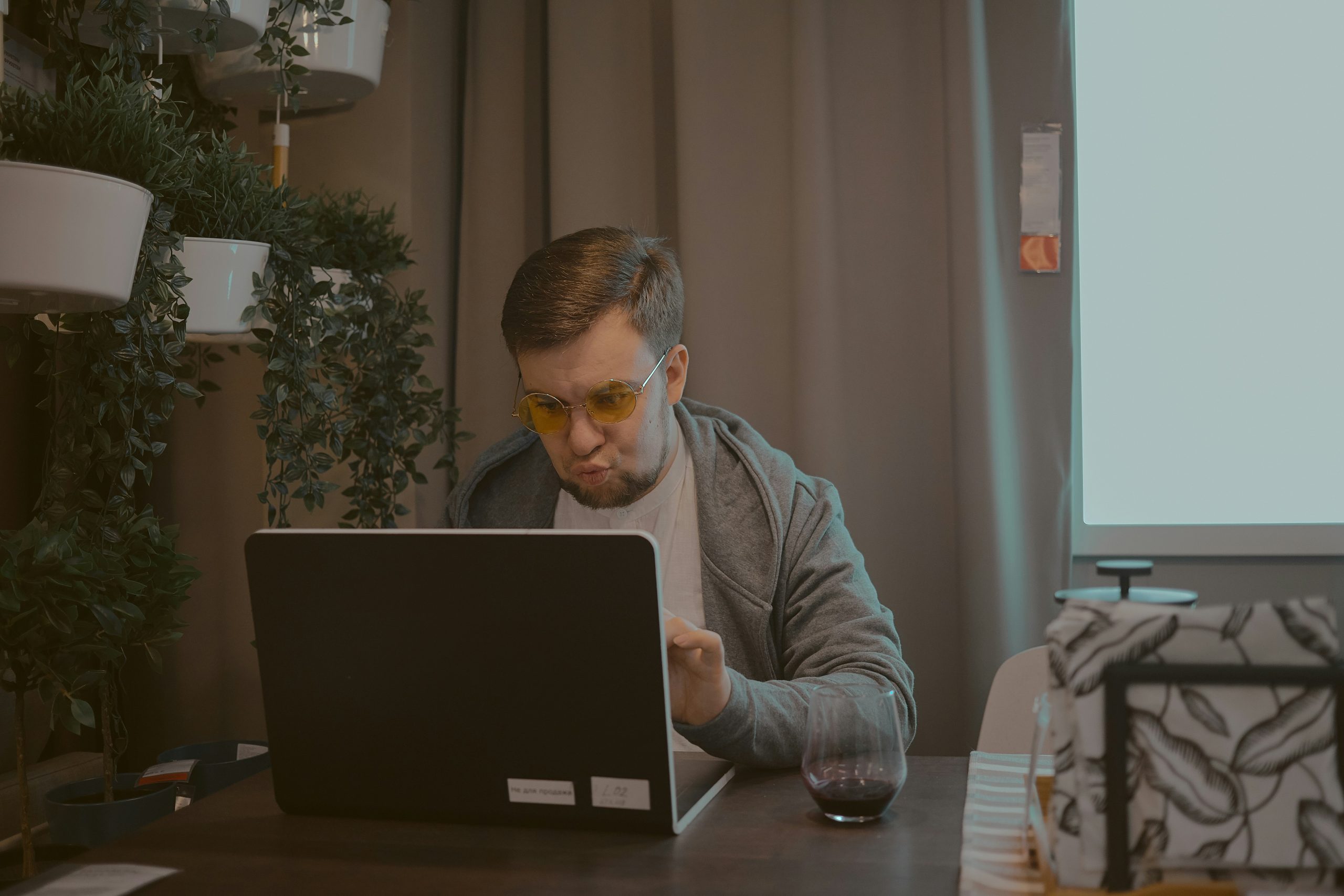 Hands typing on a laptop, displaying trading interfaces, symbolizing the monetization of AI trading signals within prop firms and social trading ecosystems.