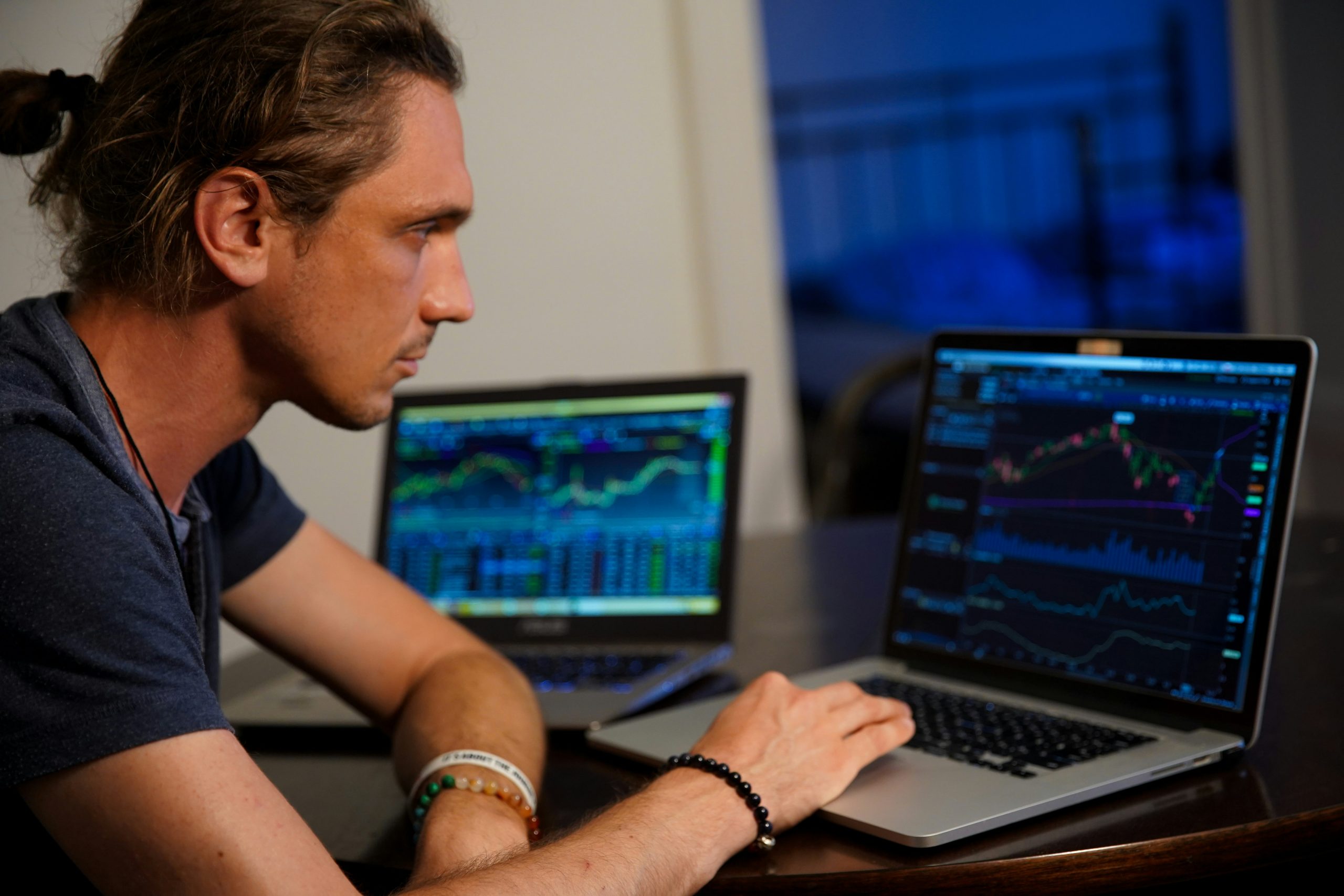 Technical Analysis Confirmation A financial professional examining gold and oil technical charts on multiple screens, confirming the bullish commodity breakout.