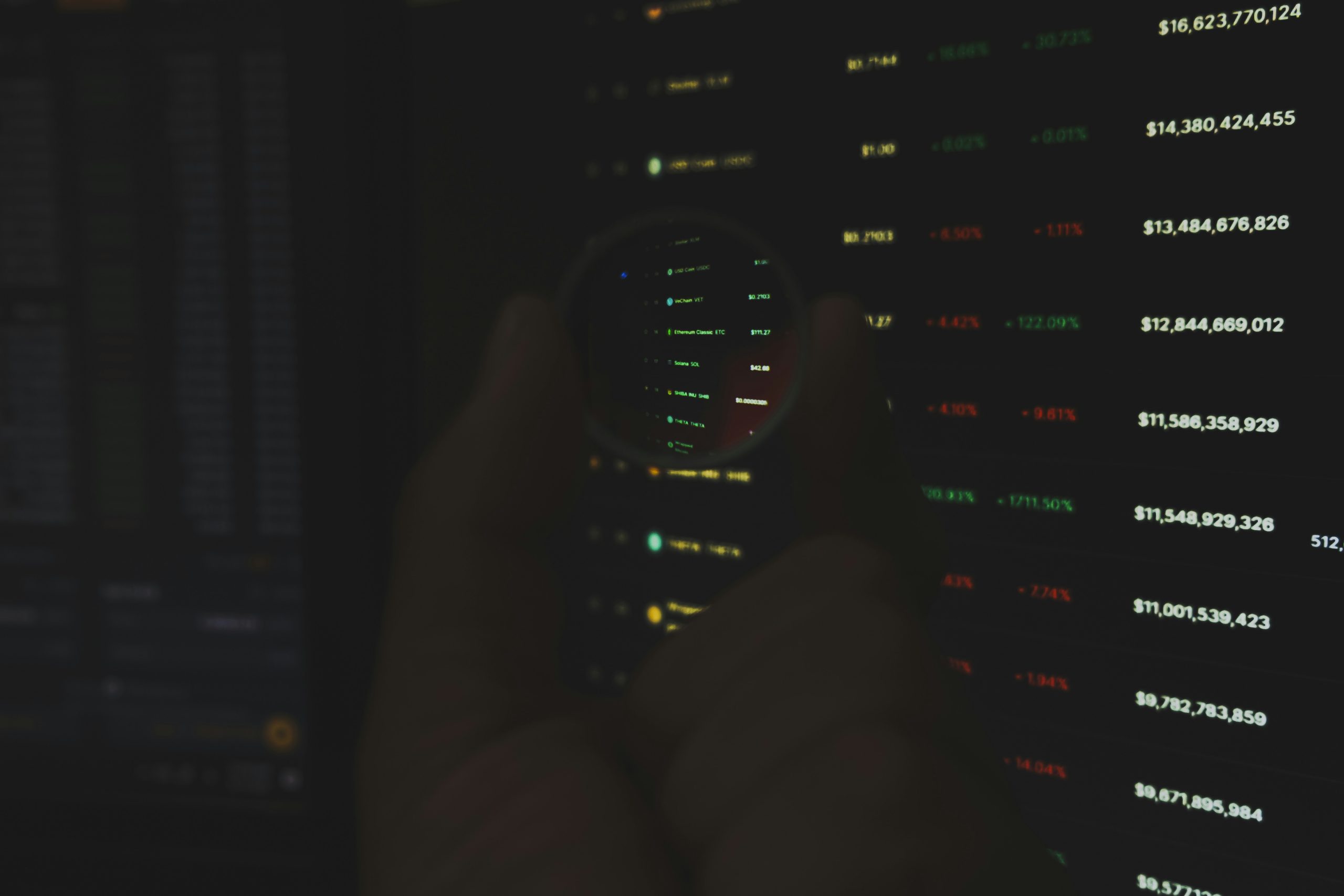 Proprietary trader focused on multiple screens displaying financial charts and cryptocurrency data, illustrating the advanced capabilities of hybrid brokerage platforms over traditional models.