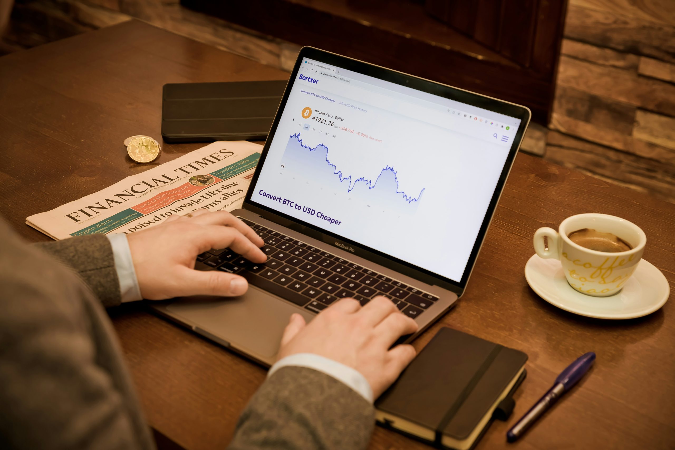 Hands typing on a keyboard with financial charts, representing volume-based fees generating stable cash flow for influencers.