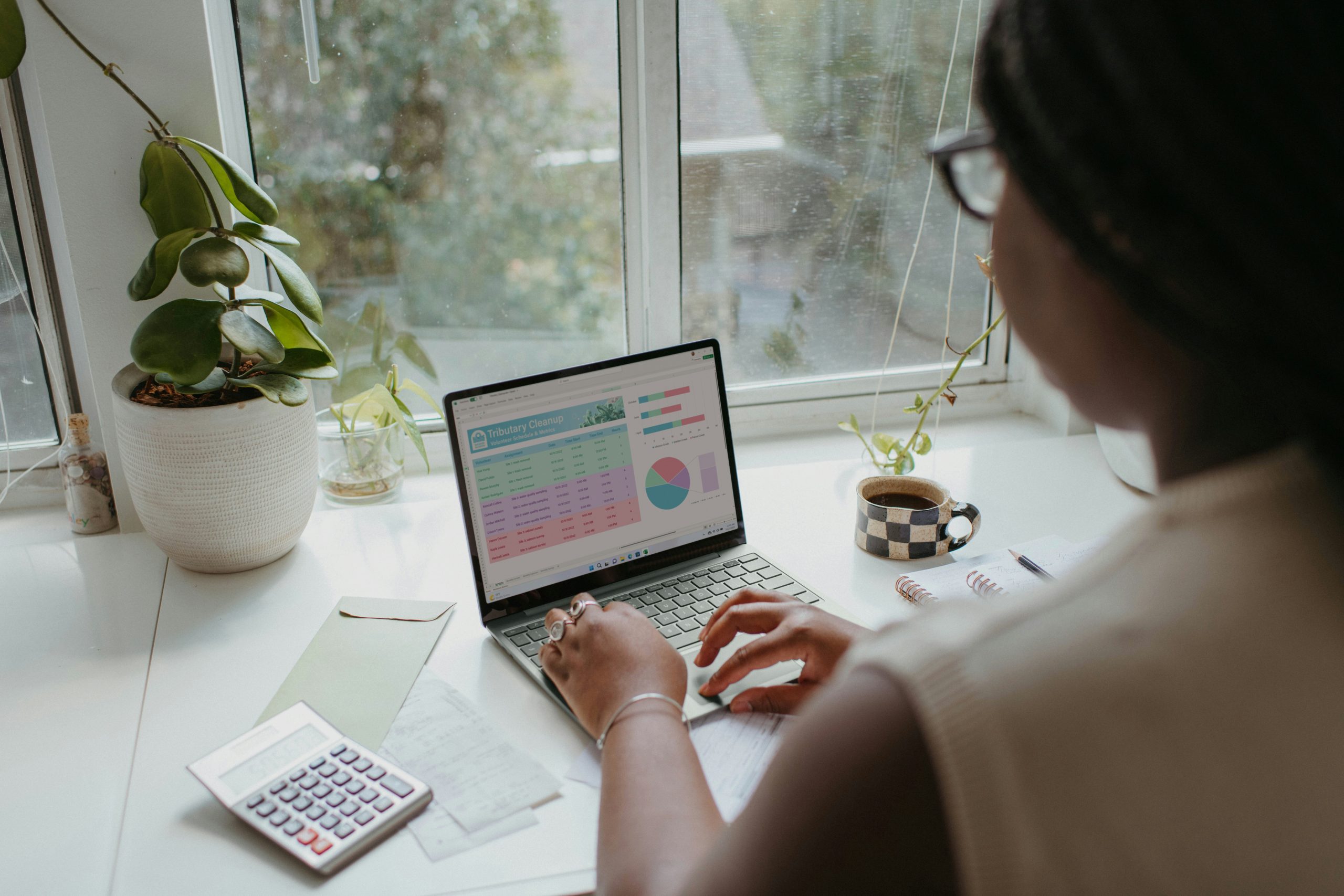 Hands typing on a laptop with financial charts visible, representing the consistent effort and value provided by management fees for long-term asset management stability.