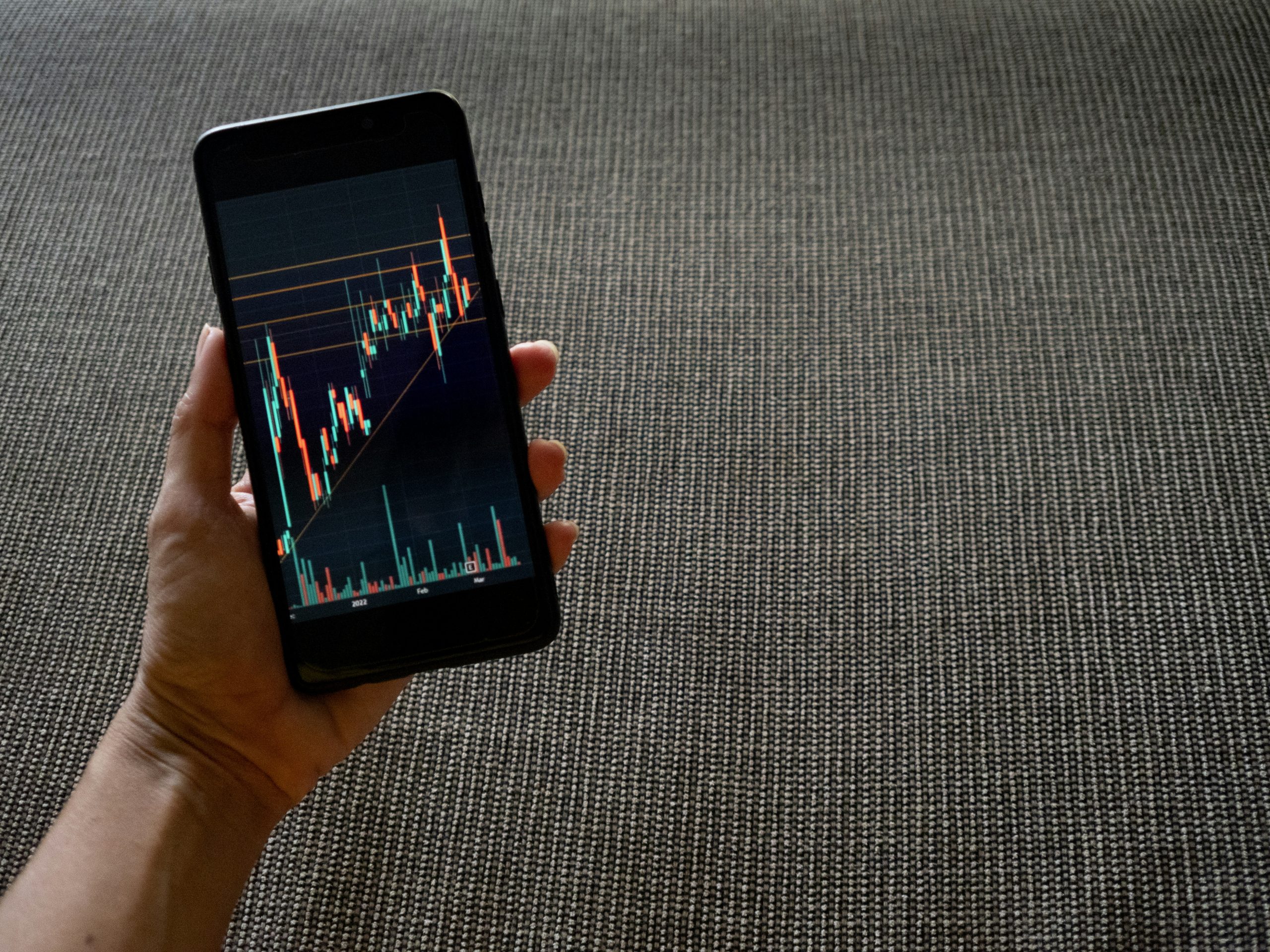 A trader viewing multiple monitors displaying financial charts and data, illustrating diverse revenue streams in a commercial-grade fee structure for wealth management.