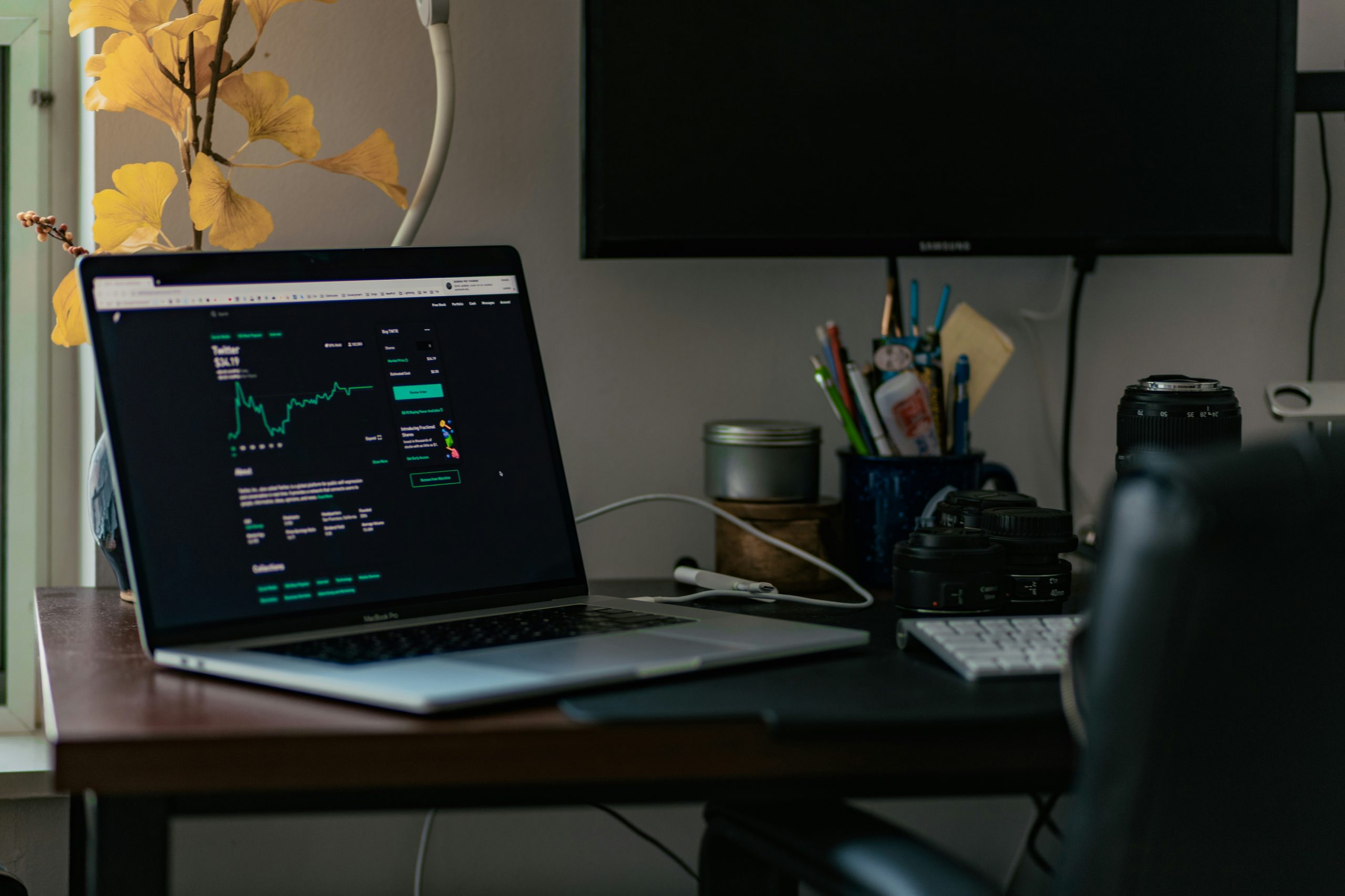 Code-free Trading Automation A person observing financial charts on a laptop screen, illustrating the evolution of automated forex trading without traditional coding.