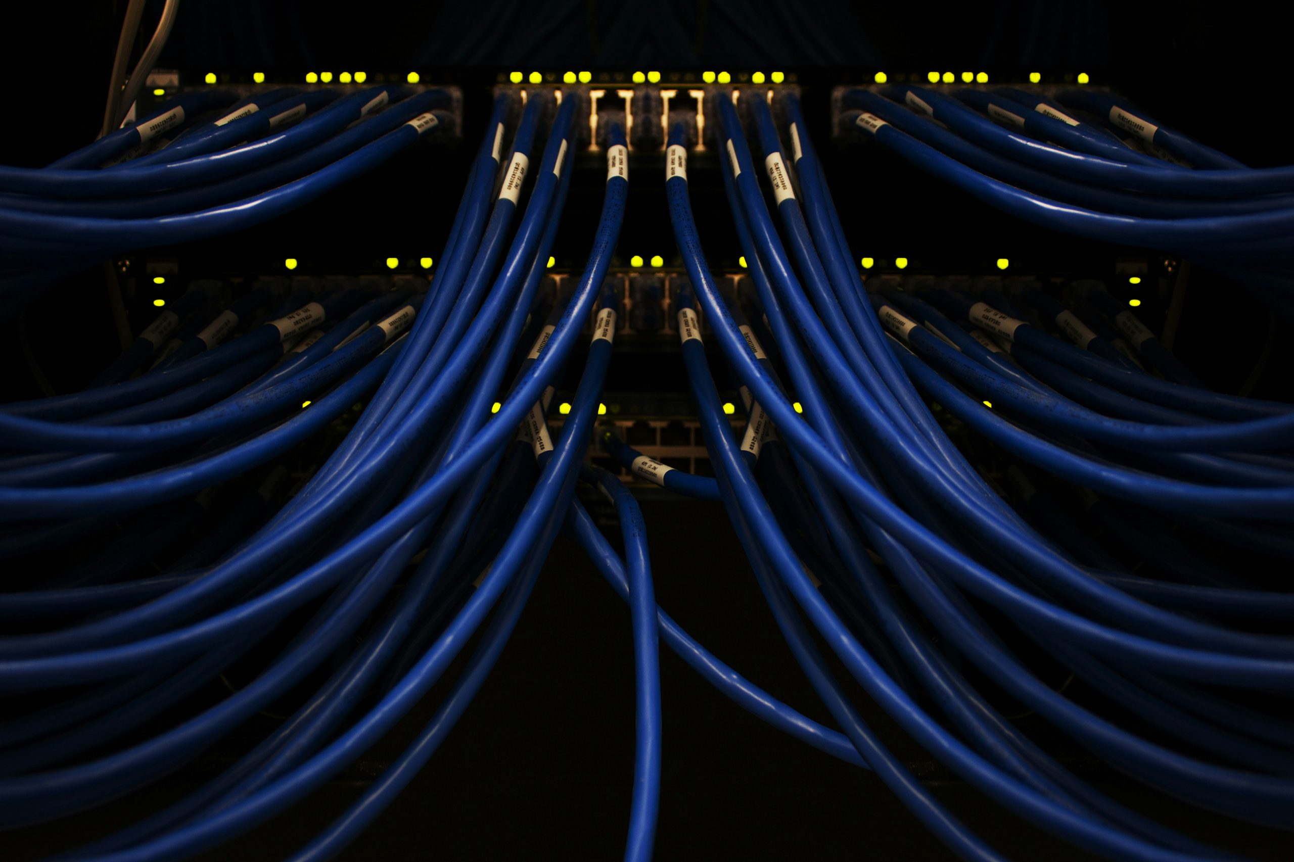 A well-organized server room with blinking lights, representing the robust technological infrastructure provided by Coinstrat Pro for scaling trading operations into institutional fund management.