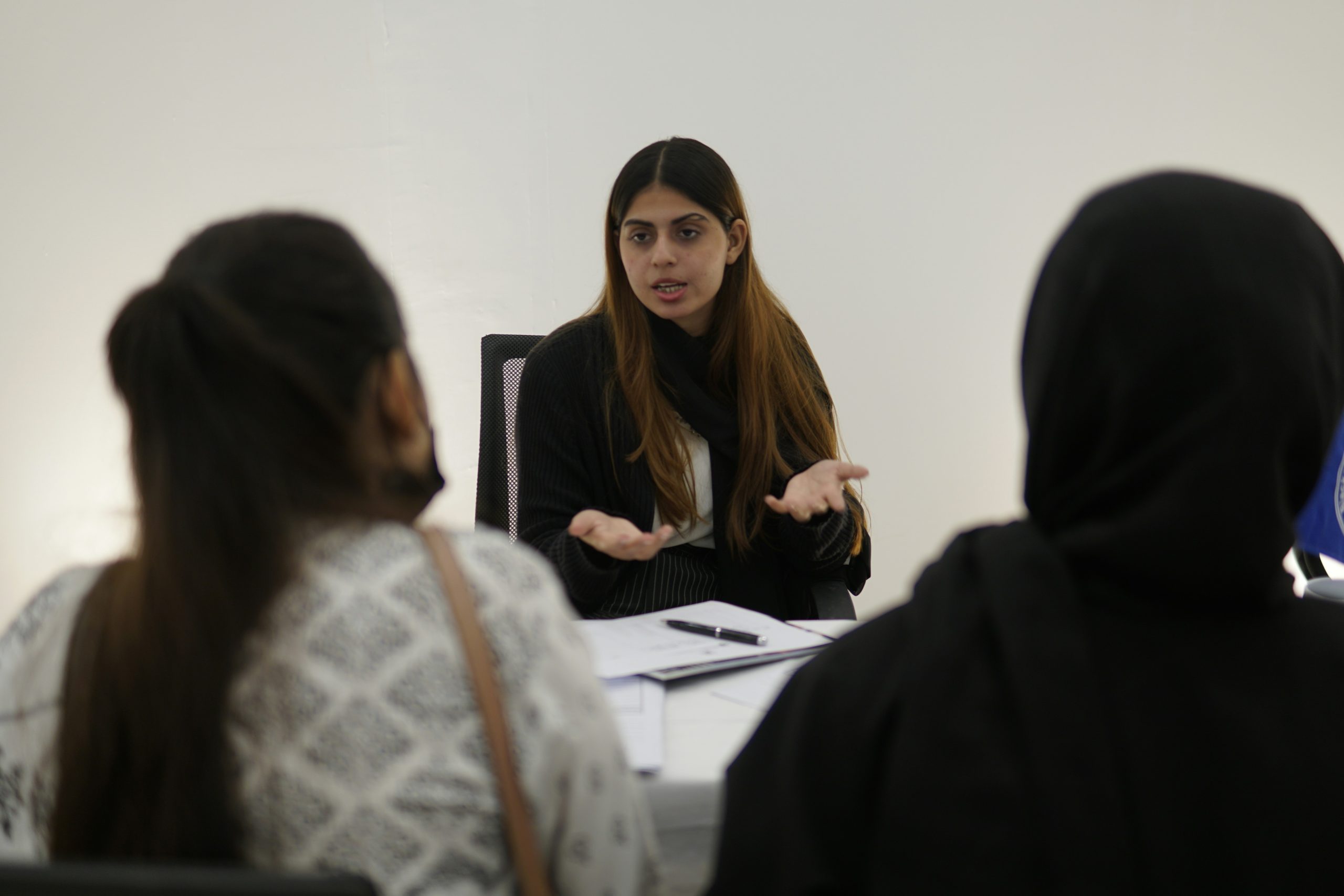 A business consultant discussing strategy with partners, symbolizing the shift from recruiter to value-added consultant in the IB business model.