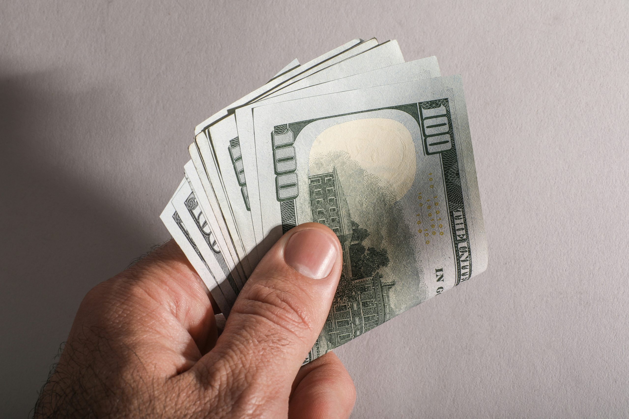 A smartphone screen showing an immediate financial transaction or rising balance, illustrating the concept of instant IB commission payouts and improved cash flow.